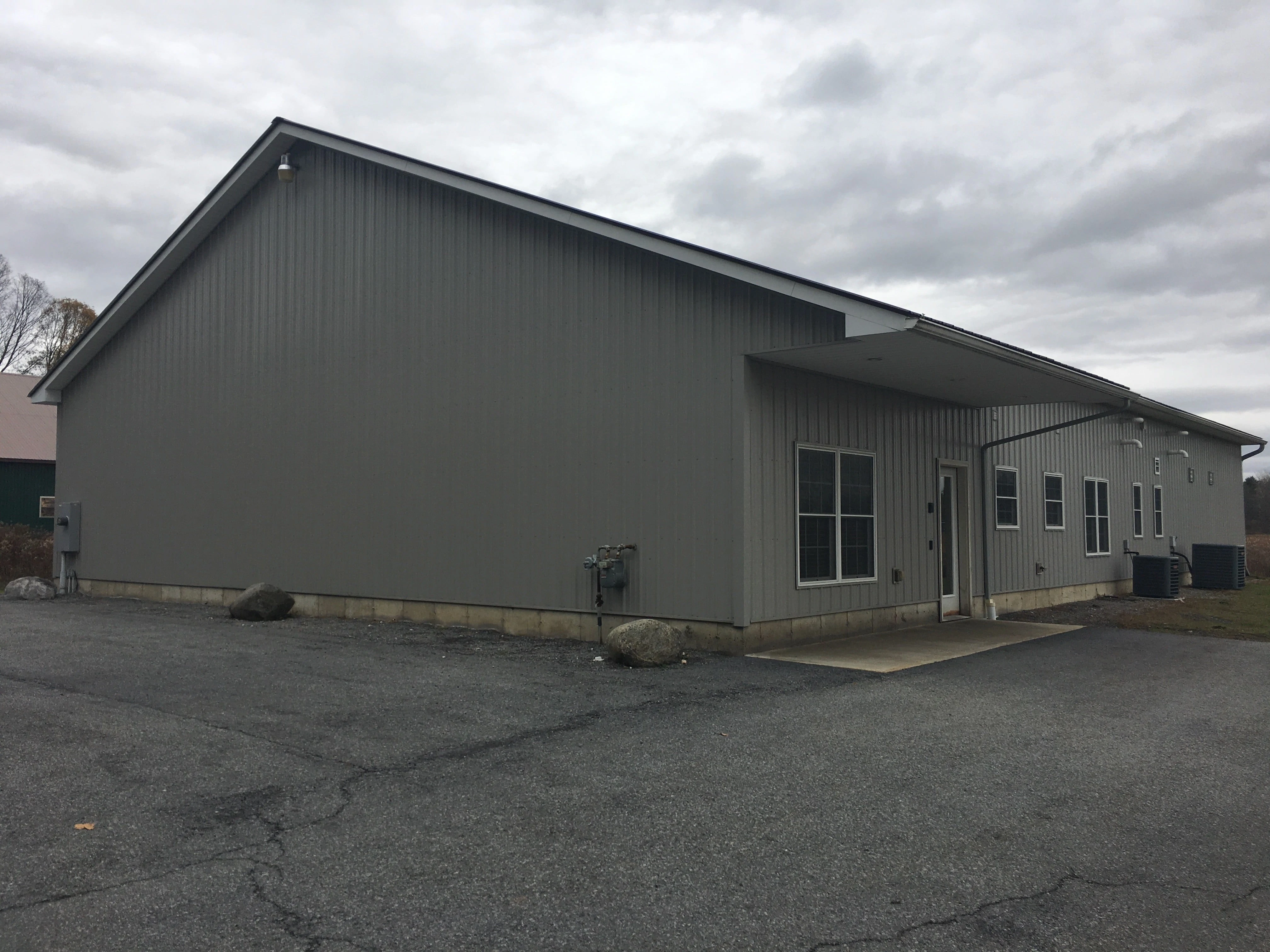 Kingsbury Printing building with entrance on the right hand side. Flat parking lot for customers with no steps to the front door.
