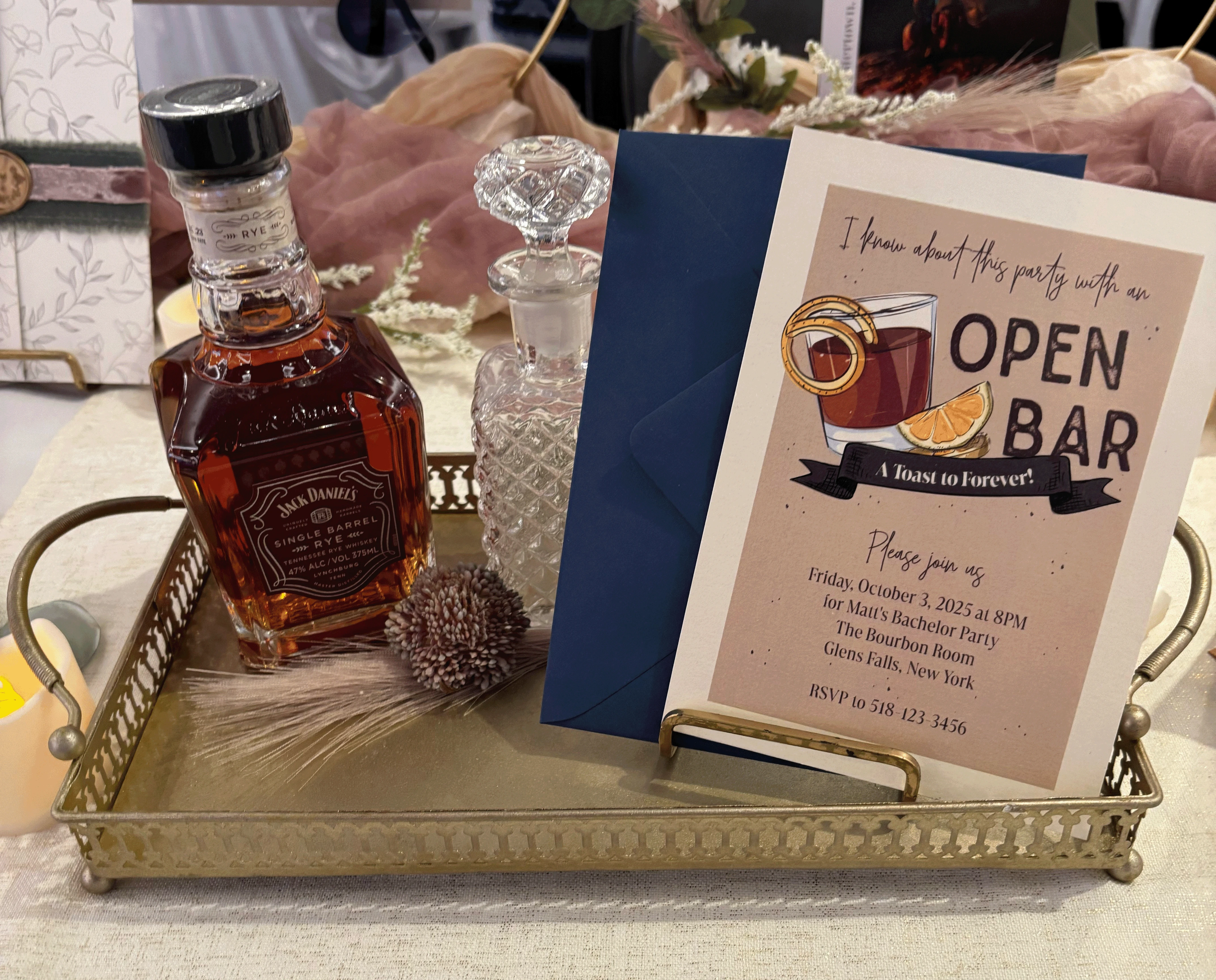 Open Bar bachelor party invitation with whisky glass design paired with a dark blue envelope.